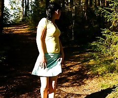 Cute brunette squats down to take a leak in forest